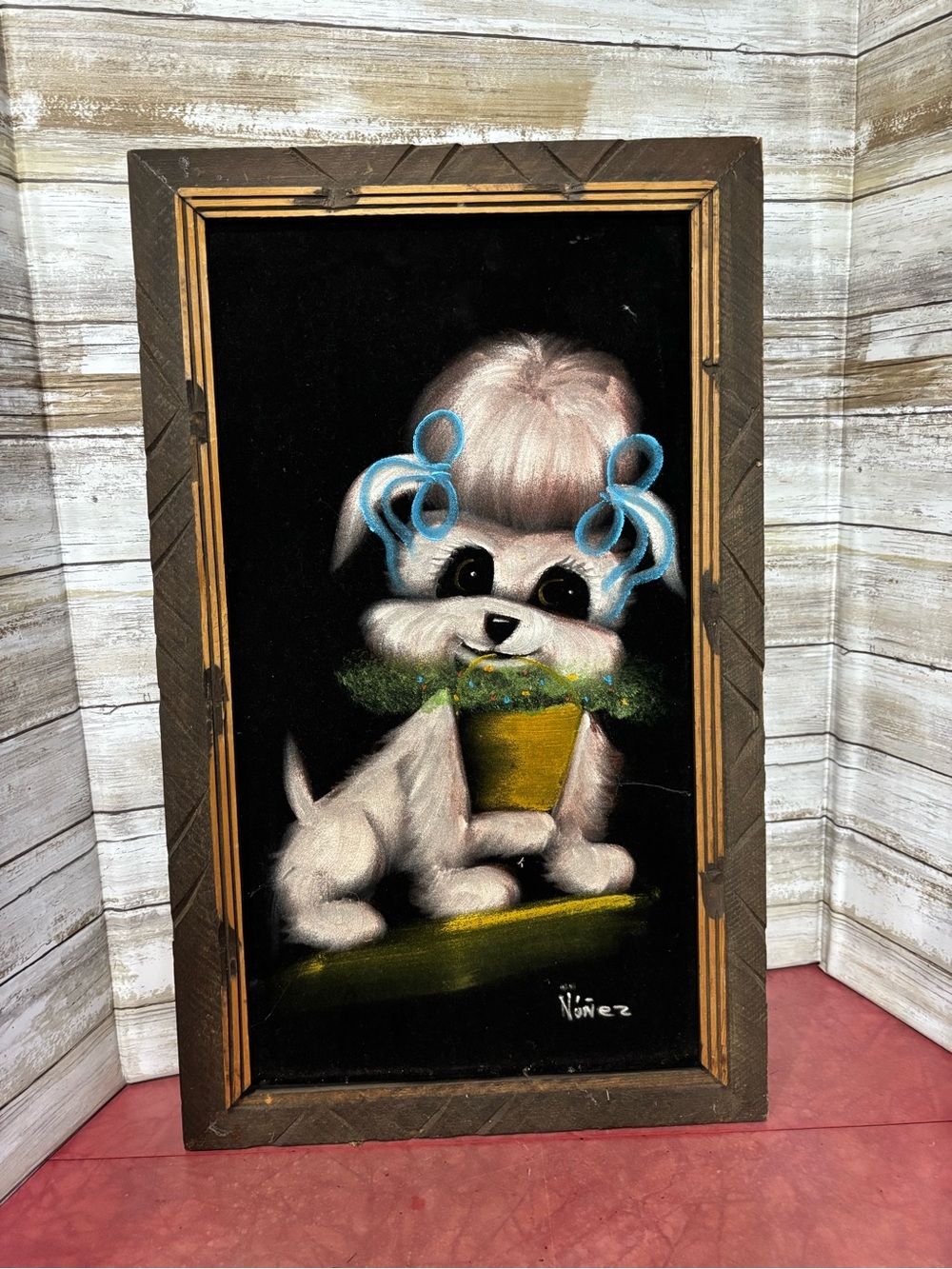 Vintage mid-century velvet painting of a cute dog with blue ribbons